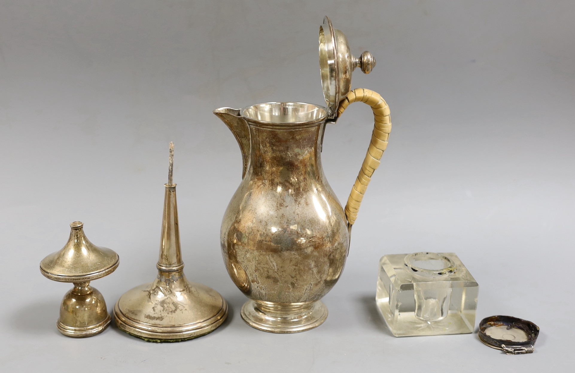 A late Victorian silver baluster hot water jug, with rattan handle, F.B. Thomas & Co, London, 1879, height 20.2cm, gross weight 12.9oz, together with a silver candlestick(a.f.) and a silver mounted glass inkwell (a.f.).